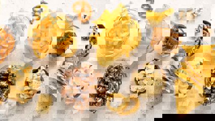 Selection Of Snack Foods Including Crisps, Popcorn And Pretzels