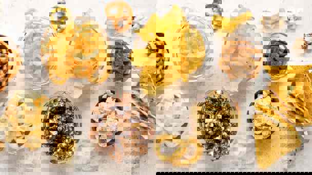 Selection Of Snack Foods Including Crisps, Popcorn And Pretzels