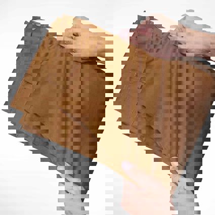 Person using hands to stretch fabric of trousers