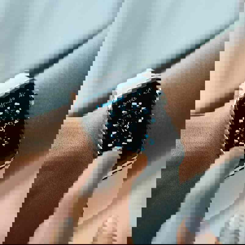 Person tapping the screen of a smart watch on their wrist