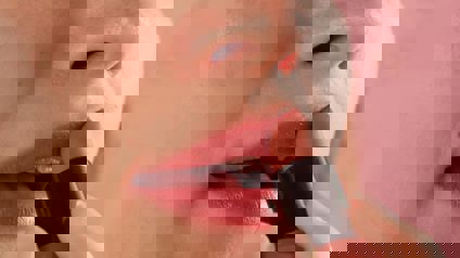 Woman Applying Lipstick