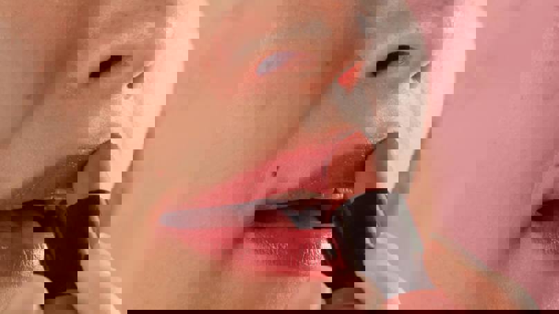 Woman Applying Lipstick