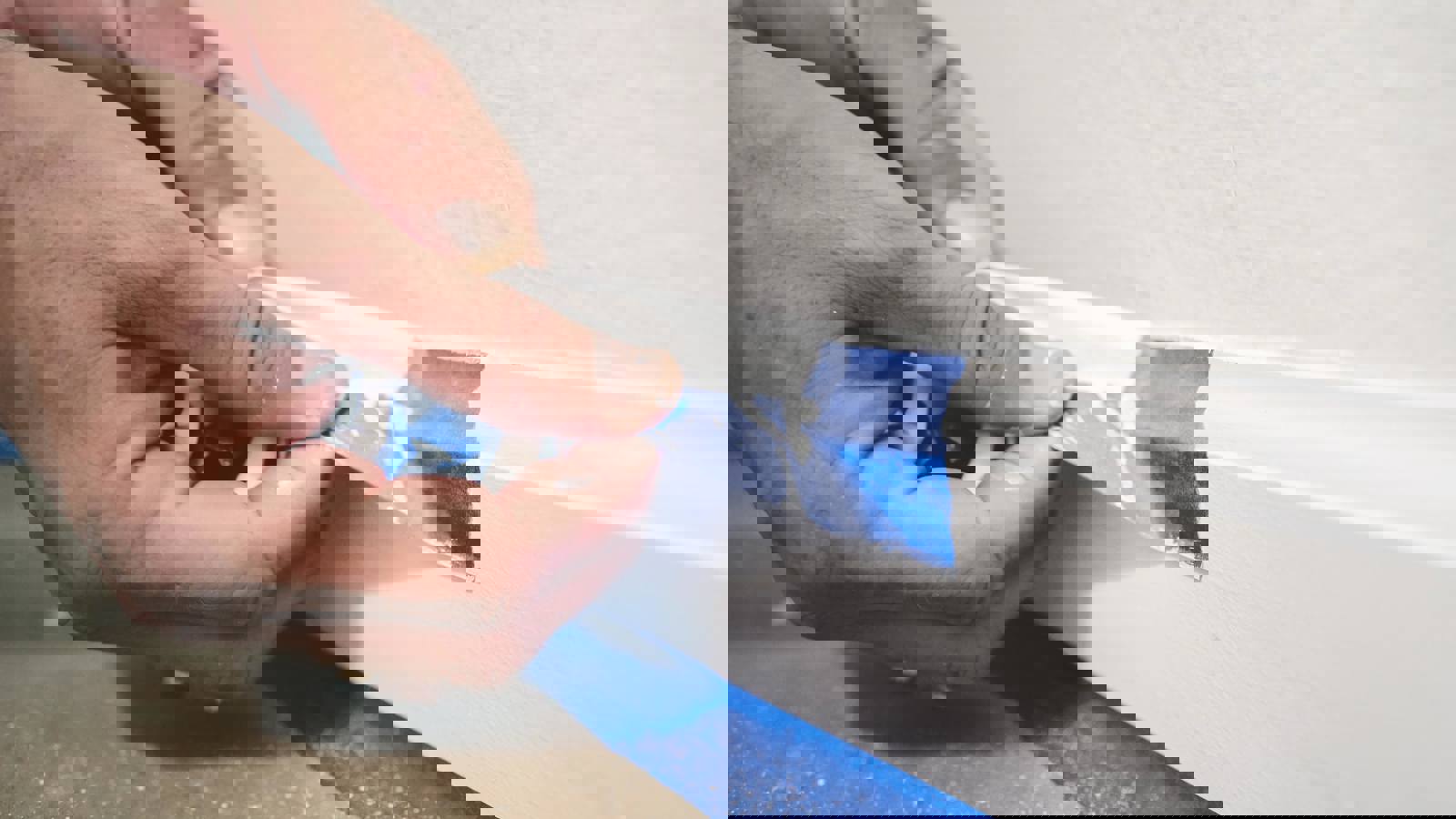 Person removing masking tape after painting a wall