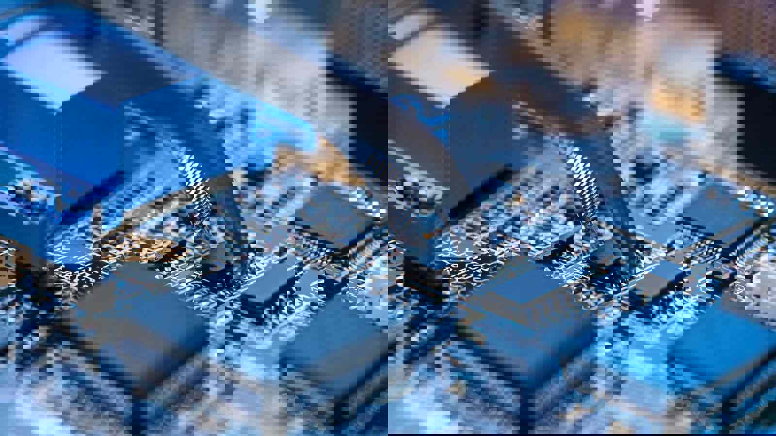 Close up of a circuit board being built with tweezers