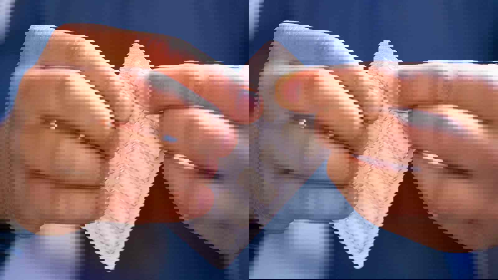 Person pushing a piece of medicated gum from a blister pack