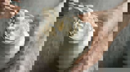 Person Scooping Mayonaise From A Jar