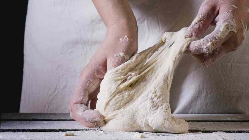 Person Stretching Dough