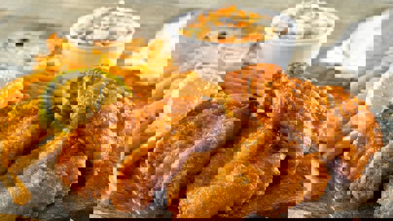 Crispy Battered Fish And Chips With Lemon Wedge