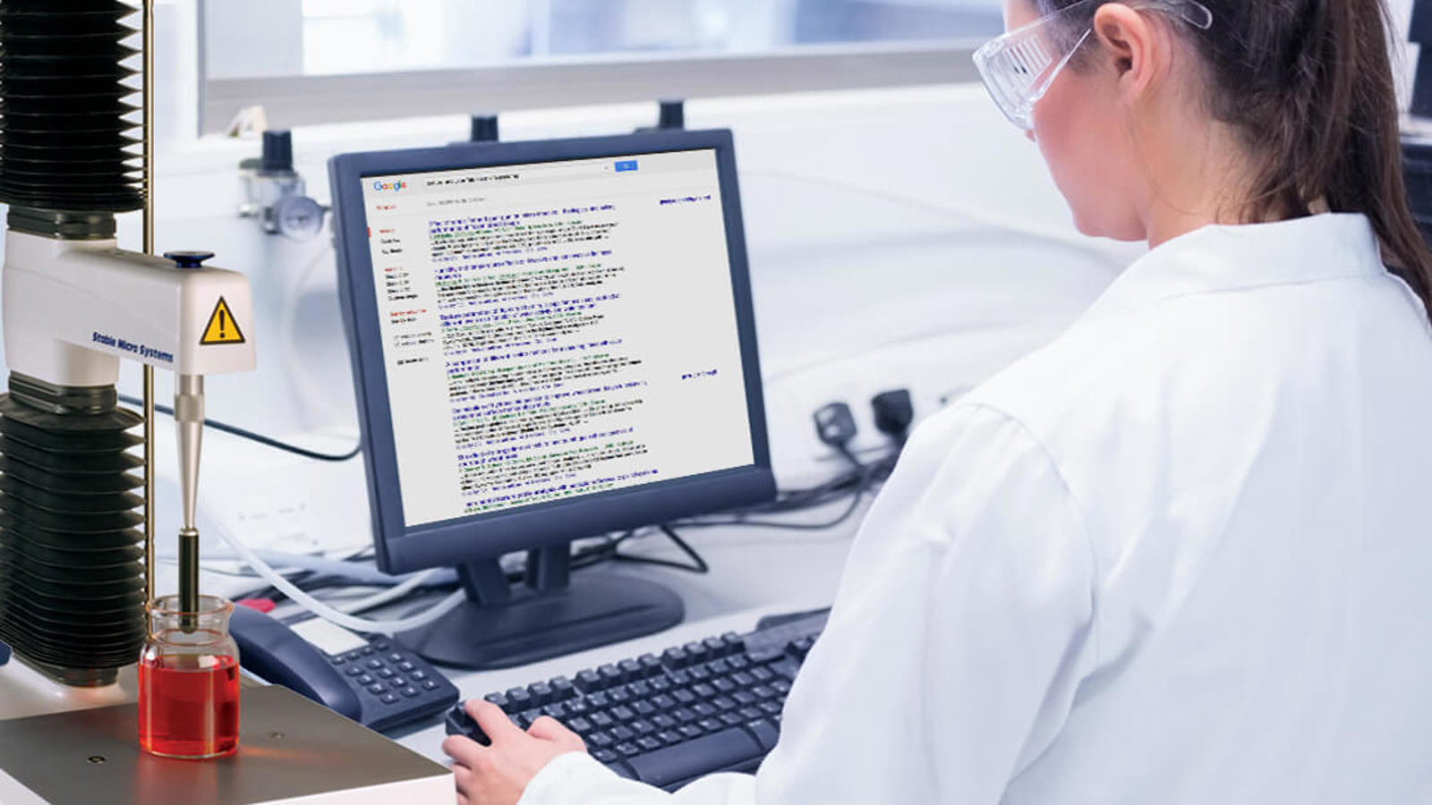 Technician researching published papers using the Texture Analyser on a computer