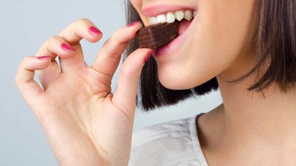 Person Biting Into A Brownie
