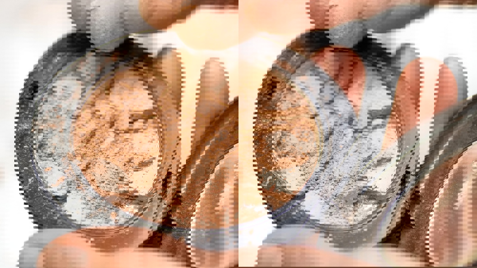 Person Holding A Makeup Compact Where The Powder Is Broken