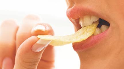 Woman Biting Crisp