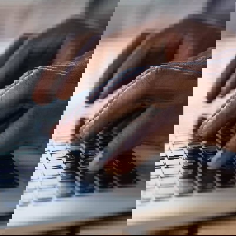 Person touch typing on a laptop