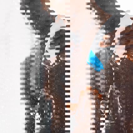 Person in shower squeezing product out of a bottle