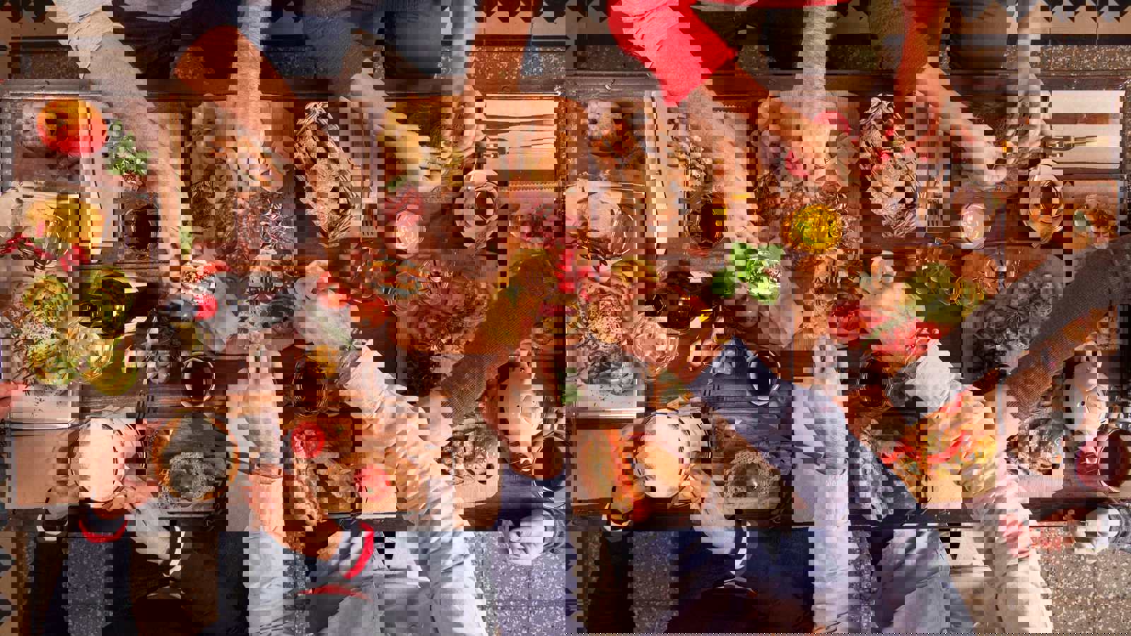Hands reaching over table sharing snacks