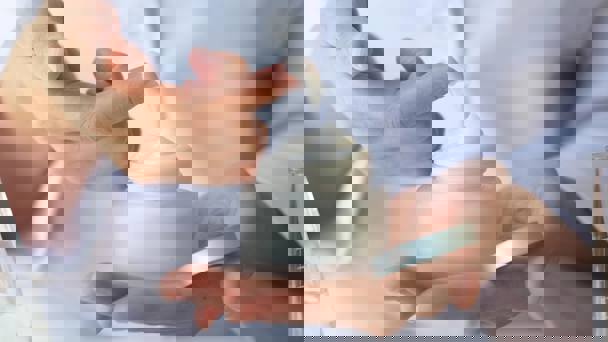 Person Holding Jar Of Face Cream