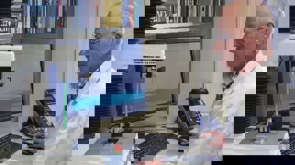 Man In White Coat Sitting At Pc Using. Texture Analyser