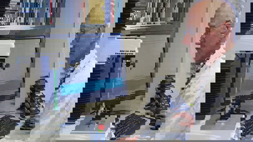 Man In White Coat Sitting At Pc Using. Texture Analyser