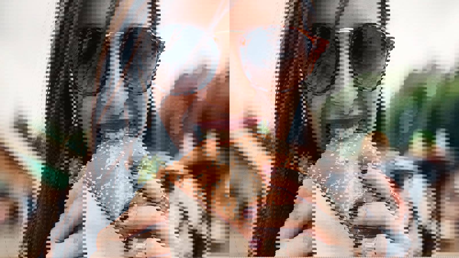 Woman biting into a burger