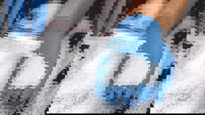 Person Measuring Polymers In Pellet Form