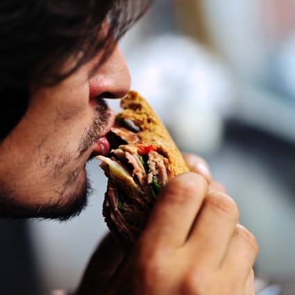 Man taking a big bite