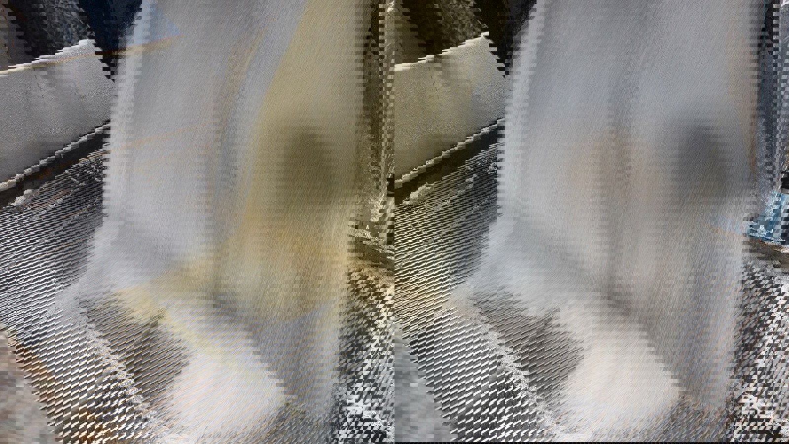 Powder flowing from a chute in a factory