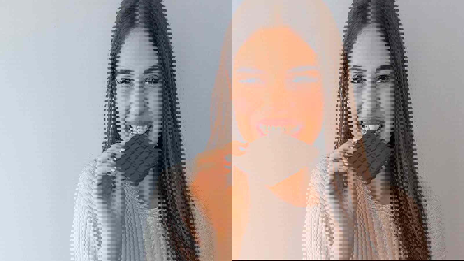 Person biting into chocolate bar