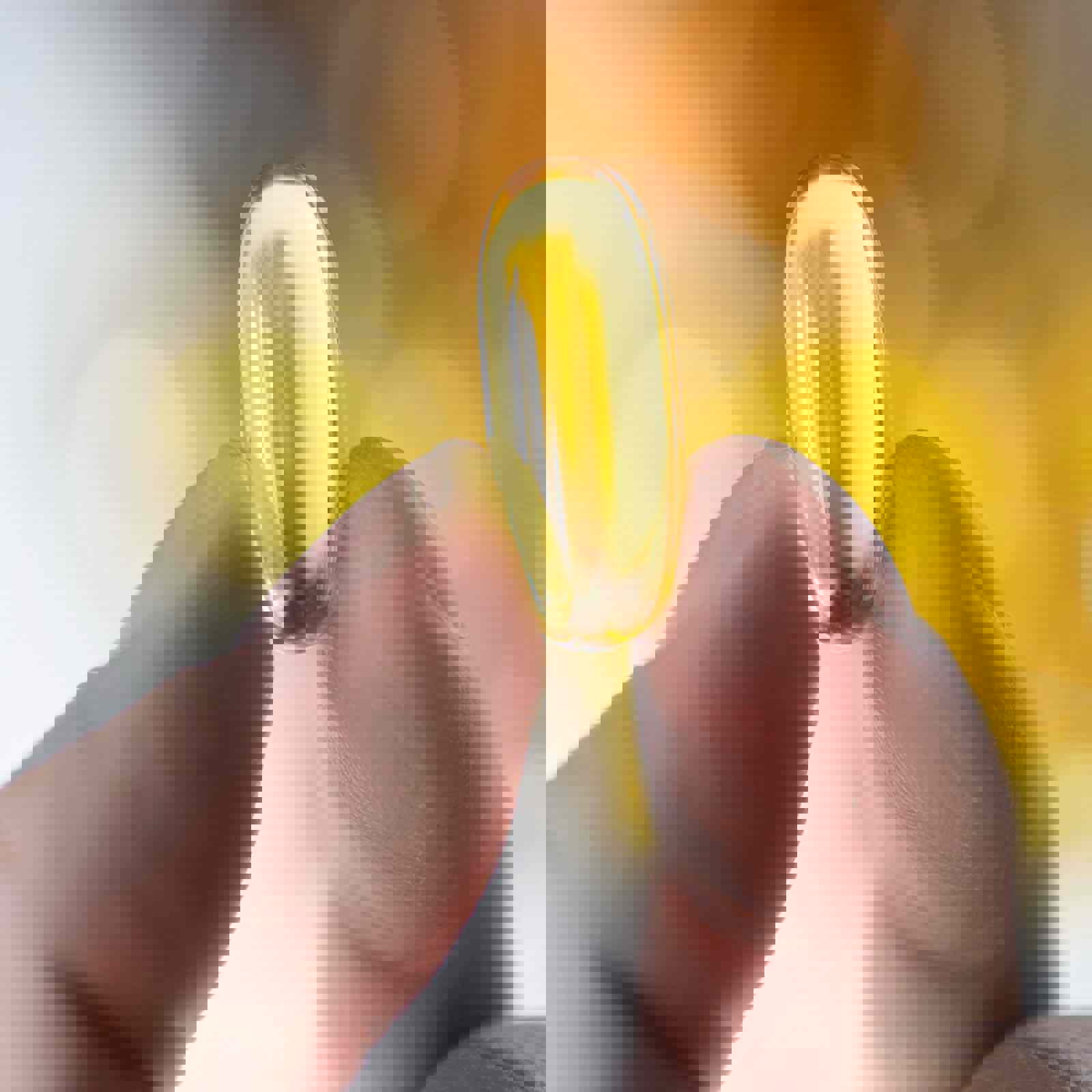 Person holding supplement capsule