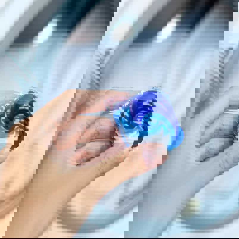 Person holding laundry gel capsule