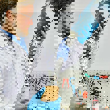 Lab technician holding a prosthetic leg