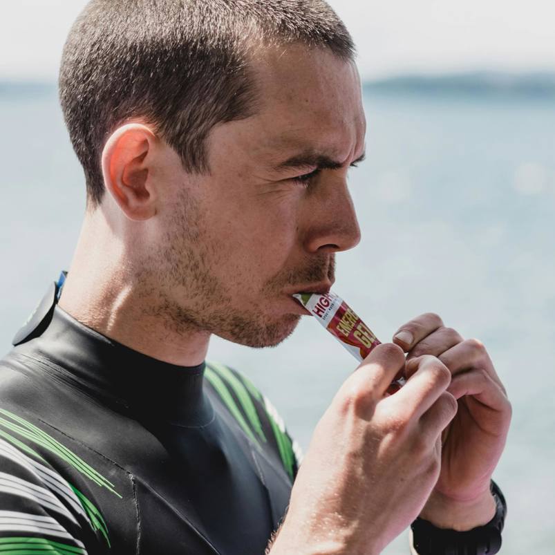Surfer consuming an energy sachet