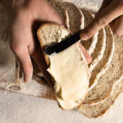 Spreading butter thickly on bread