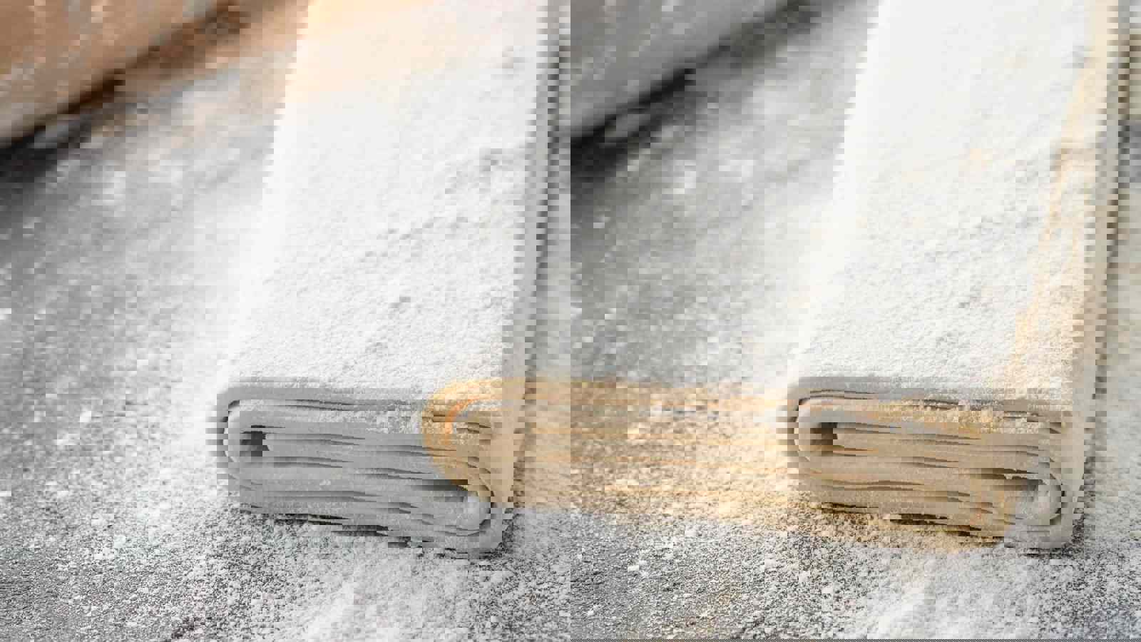 Raw puff pastry on floured surface