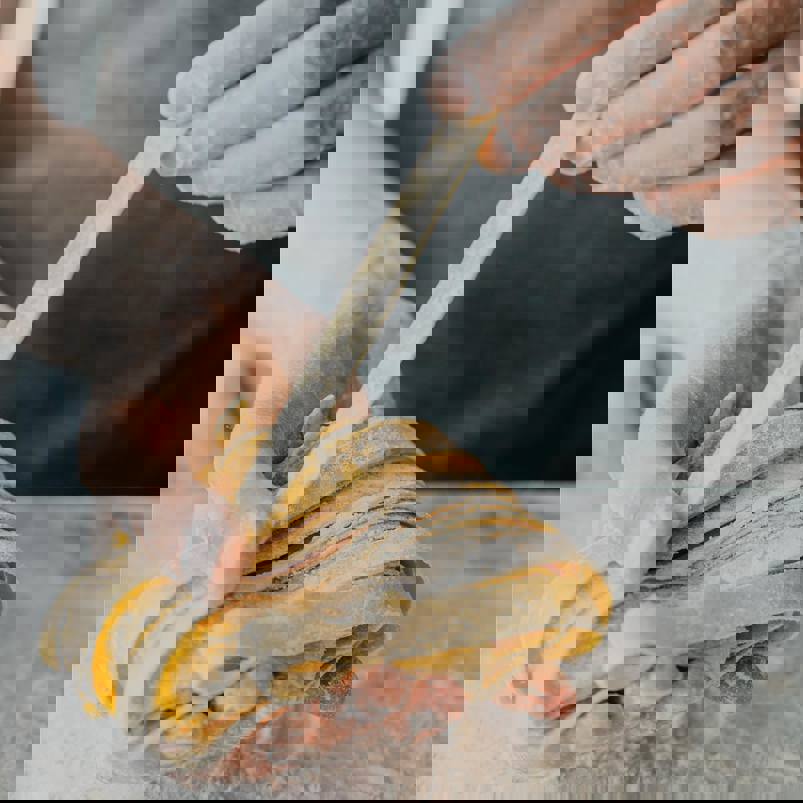 Person holding freshly made pasta