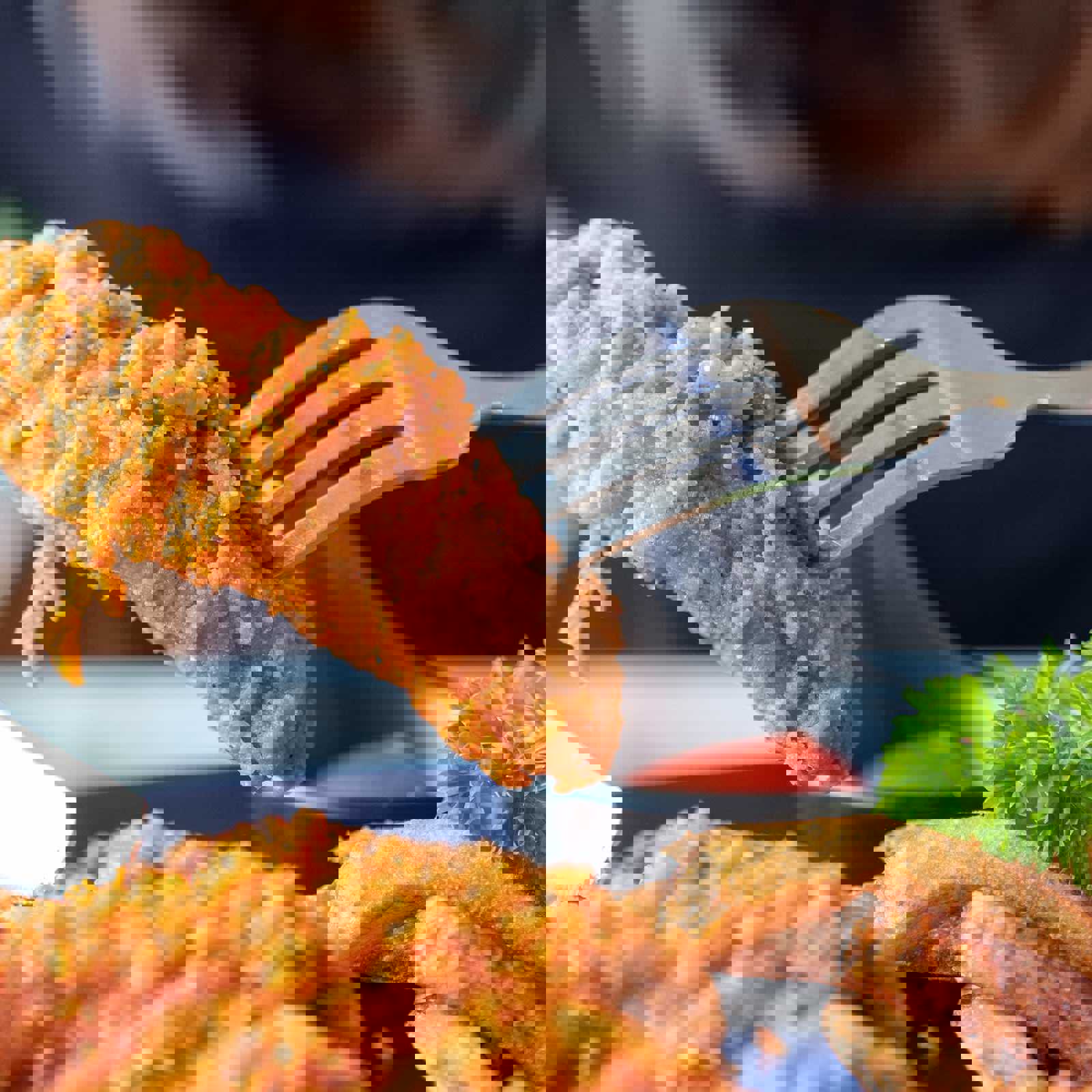 Person picking up fried chicken with a fork