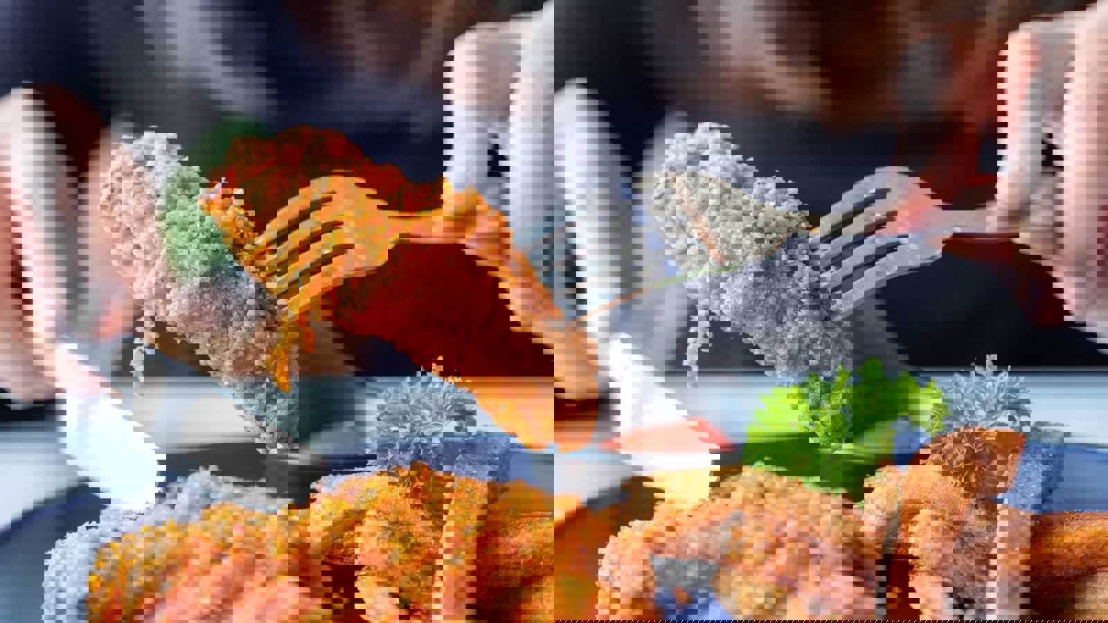 Person picking up fried chicken with a fork