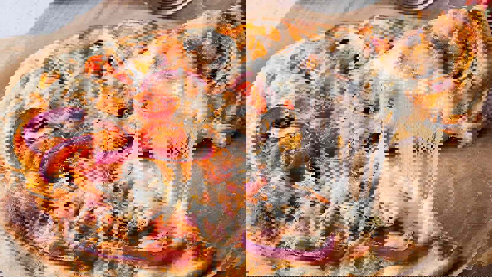 Slice of cheesy pizza being separated 