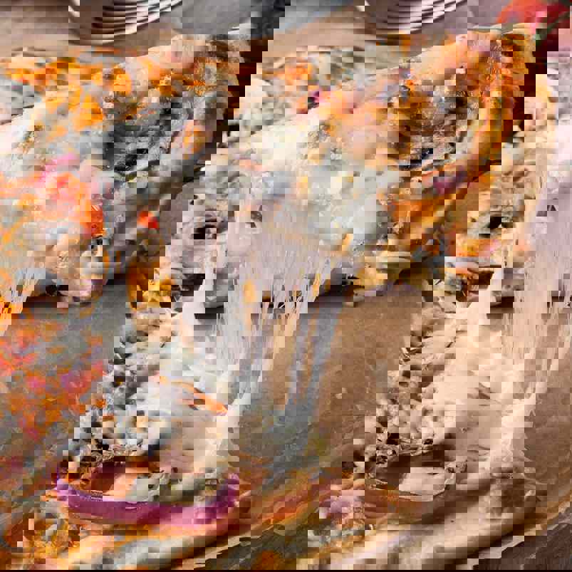 Slice of cheesy pizza being separated 