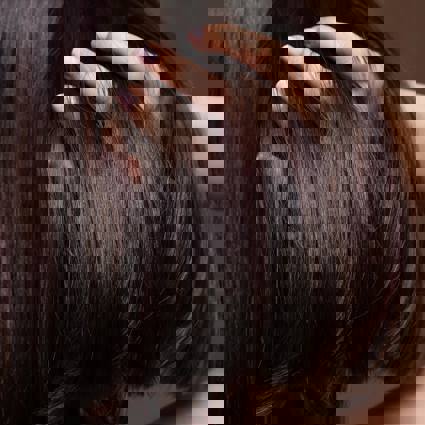 Person running fingers through hair