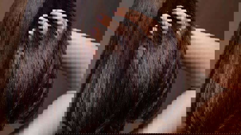 Person Running Fingers Through Shiny Hair