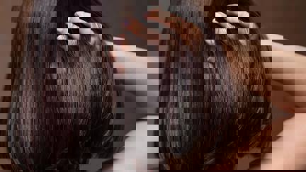 Person Running Fingers Through Shiny Hair