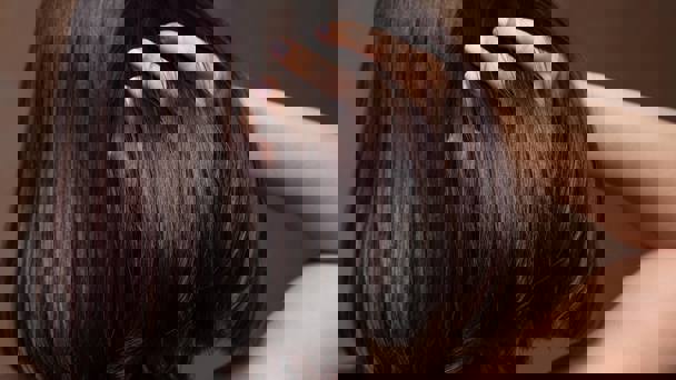 Person Running Fingers Through Shiny Hair
