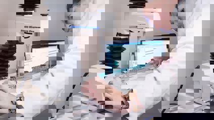 Woman In White Coat Preparing A Test On A Texture Analyser