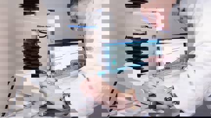 Woman In White Coat Preparing A Test On A Texture Analyser