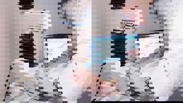 Woman In White Coat Preparing A Test On A Texture Analyser