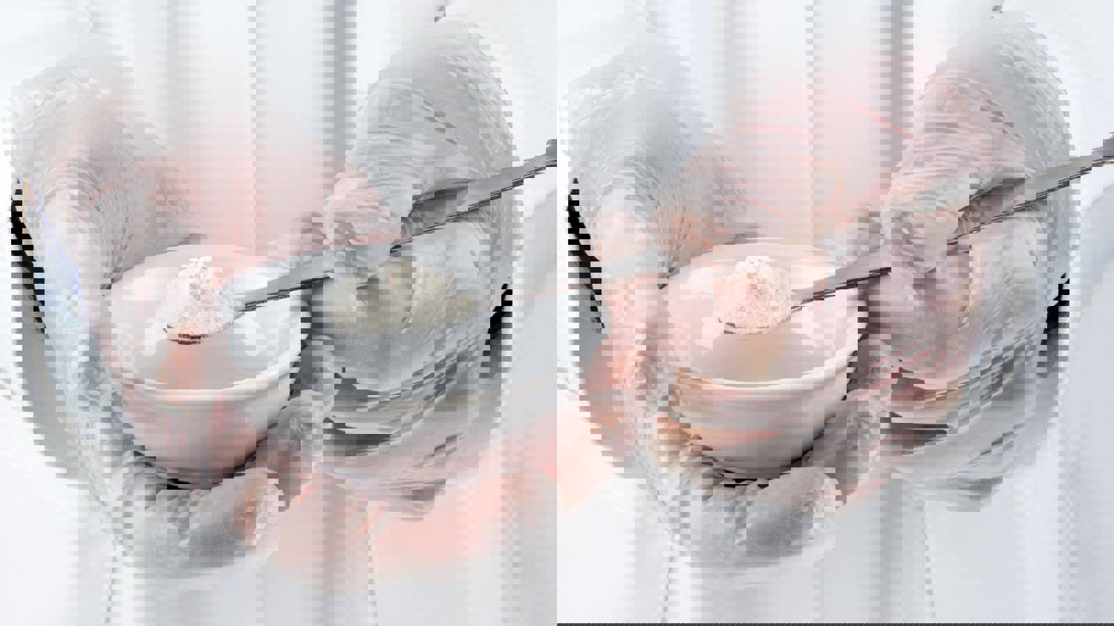 Lab technicial holding spoon of white powder