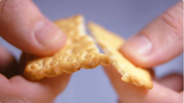Cracker Being Snapped In Half