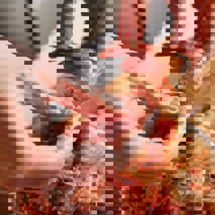 Person peeling prawns