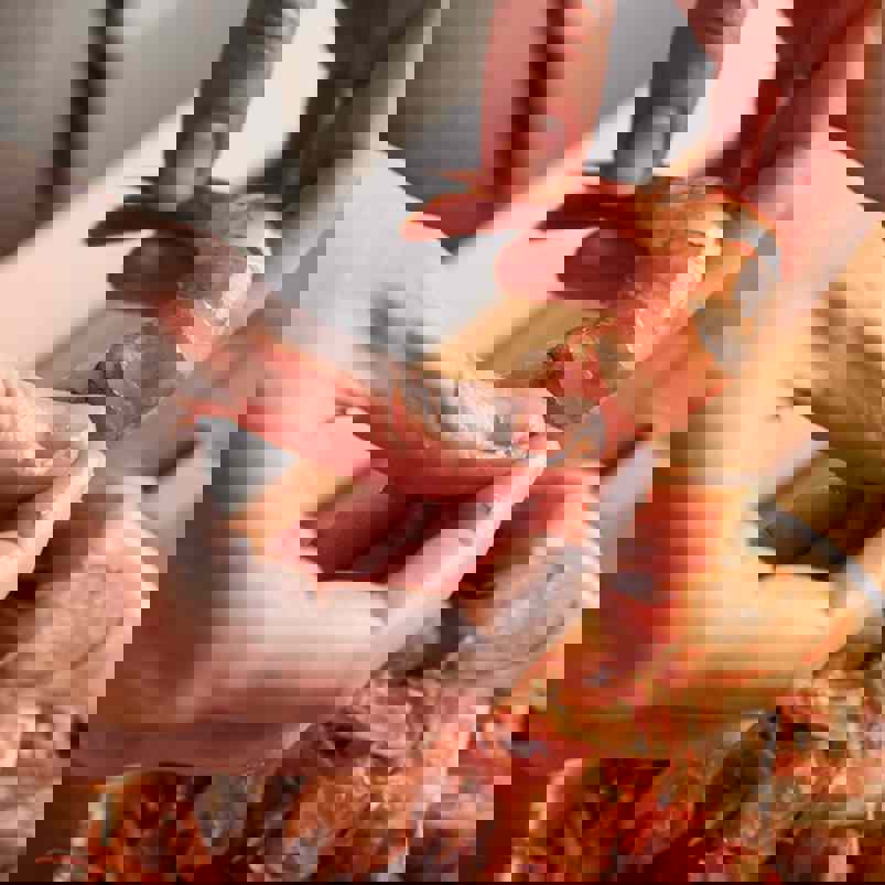 Person peeling prawns