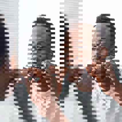 Person flossing teeth in mirror